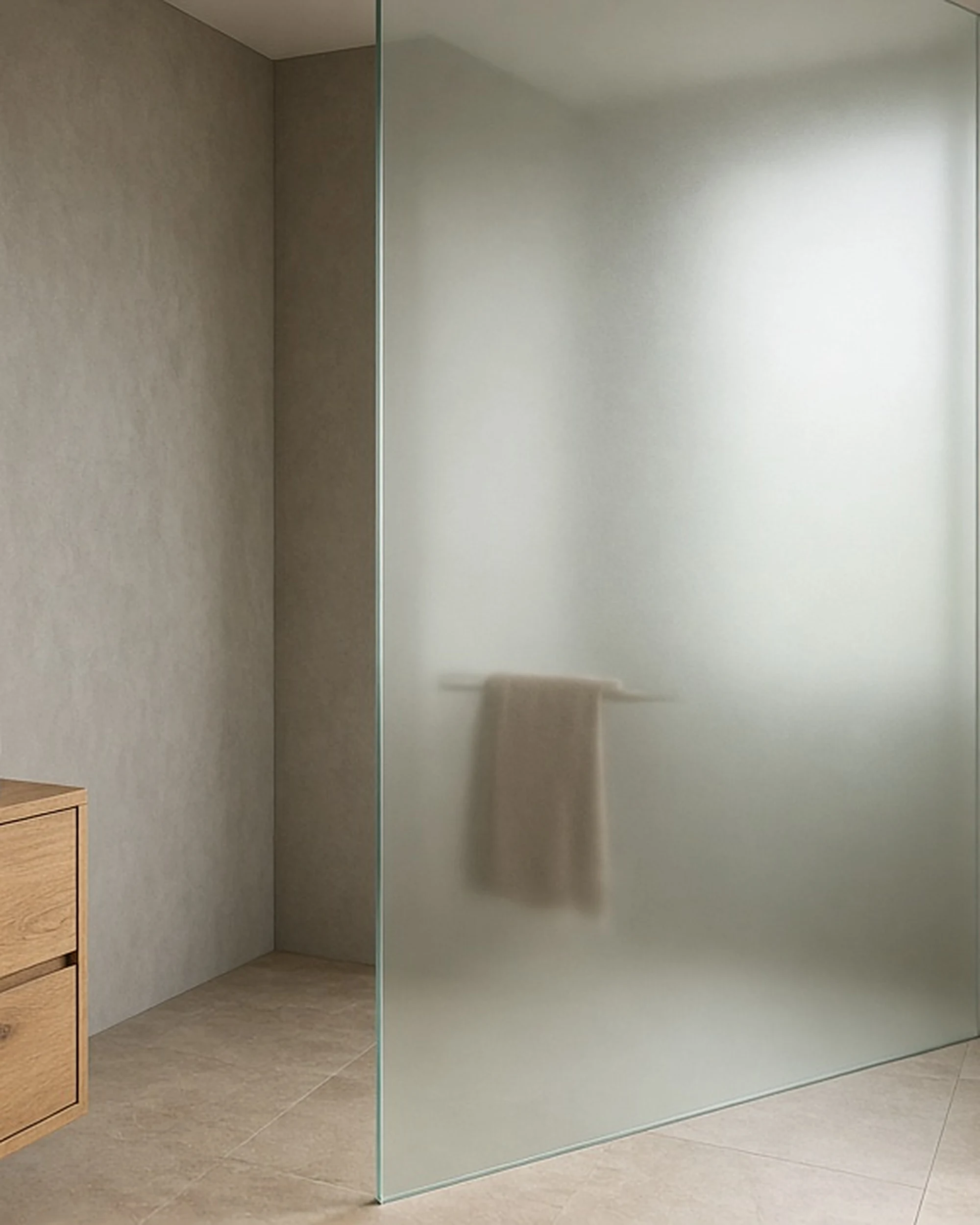 Clear satin acid-etched glass privacy panel in a bathroom, illustrative render